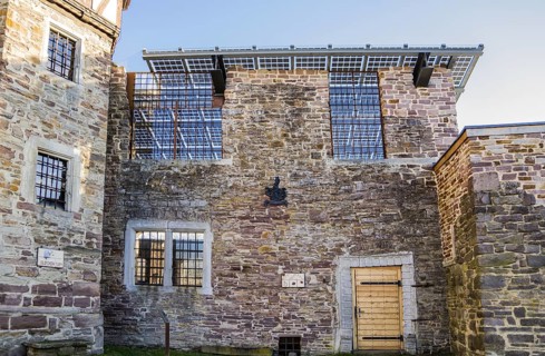 Old castle with modern photovoltaic system as the roof of the concert hall, Wülmersen moated