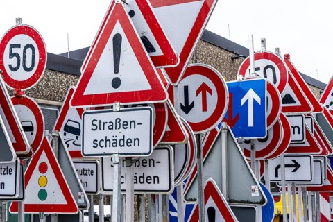 Storage for traffic signs in the yard of a road maintenance department, various signs with