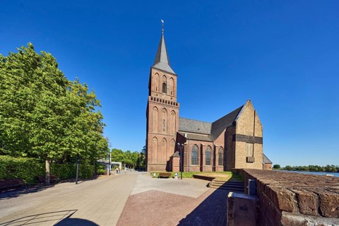 St. Martini church, church tower, parish church, brick wall, hedge, trees, blue sky, cloudless,