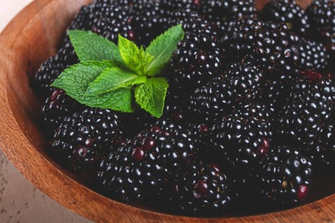 Blackberries, in a wooden bowl, top view, no people