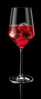 Wine glass filled with ice cube cubes and cocktail in front of a black background, studio shot