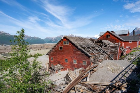 Red Kennicott buildings in front of mountainous landscape, Kennicott Concentration Mill to extract