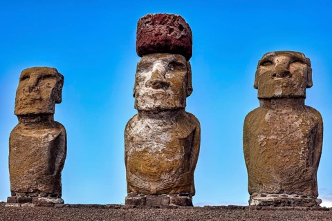 Three Moai statues stand under a clear blue sky, The Moai Statues on Easter Island in the Pacific