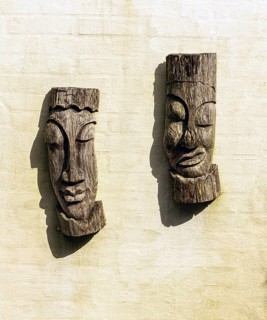 Old African wooden mask sculptures over a white wall