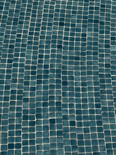 This image showcases an irregular blue mosaic pattern made of small square tiles. The textured