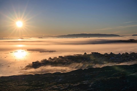 Inuit settlement in front of icebergs in the fog, midnight sun, summer, Ilulissat, Ilulissat