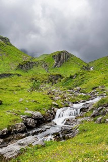 Bergbach Sousbach flows through picturesque green mountain landscape, long exposure, Bernese Alps,