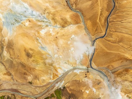 Steaming hot springs and colourful rhyolite mountains, aerial view, Hveradalir geothermal area,