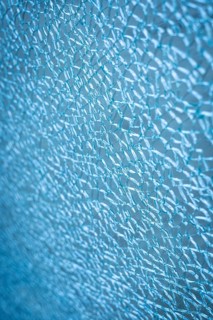 Frozen abstract texture resembling winter frost or cracked ice surface. Delicate crystalline
