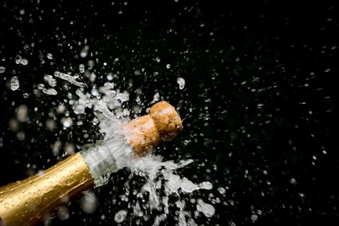 A champagne bottle is opened, sparkling wine, champagne cork flies out, champagne, celebration, New