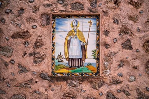 Baldosa, image of a saint, wall tile on the wall of a house, artist village Deià, Tramuntana
