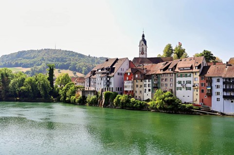 Cityscape with St. Johann Roman Catholic Church and historic houses on the banks of the Rhine