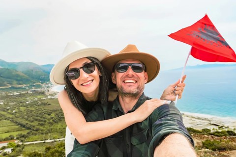 Happy young pretty woman handsome woman tourist enjoying summer holiday in Sarande, Albania -