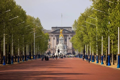 The tree lined avenue of The Mall stretches toward Buckingham Palace and the Victoria Memorial,