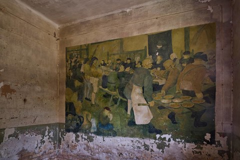 Old wall painting in a dilapidated room showing a group of people eating, Lost Place, Tourtouras
