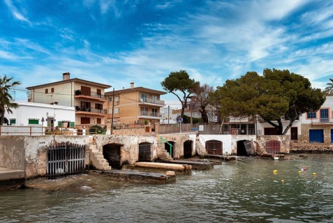 Old and dilapidated boat shelters that are not being used, old port area in Portocolom on the east