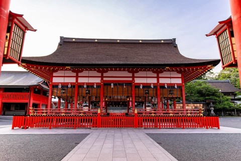 The vibrant entrance of Fushimi Inari-taisha in Kyoto, Japan, displays traditional architecture