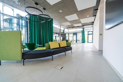 Modern lobby with open room design and green curtains