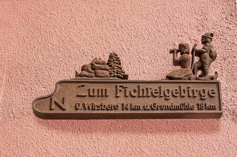 Carved signpost on a house wall, Kulmbach, Upper Franconia, Bavaria, Germany