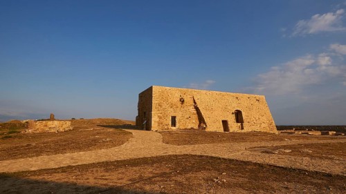 Drone shot, Fortezza, Venetian sea fortress, building inside the fortress, blue sky, few grey-white