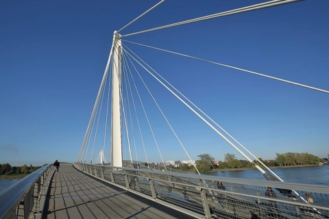 Modern cable-stayed bridge Passerelle des Deux Rives across the Rhine, footbridge with white