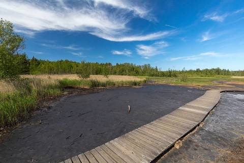 Boardwalk thru a volcanic active area with mofette. Geological park Soos, Soos National Nature