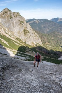 Mountaineer in a steep scree cirque, hiking trail to the Bavarian Schinder, Bavarian Prealps,