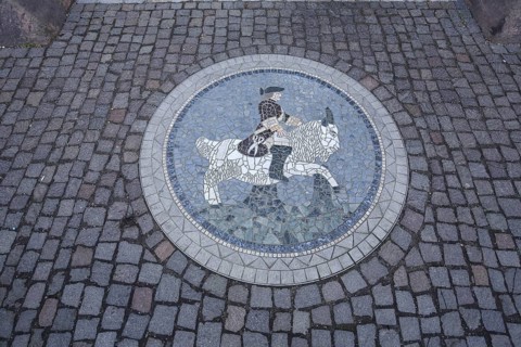 Round floor mosaic with rider on a bull, nobleman in historic clothing, handicrafts, museum,