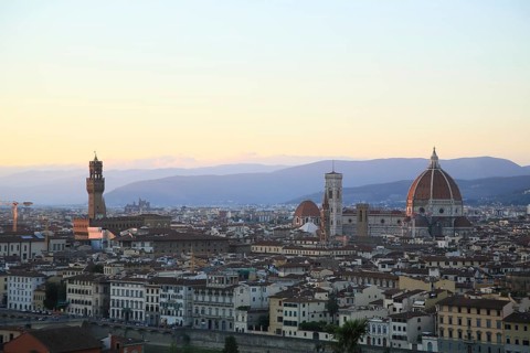 Panoramic view of Florence at dusk with the cathedral and surrounding historic buildings, sunset