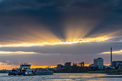 Cargo ship on the Rhine between Duisburg and Krefeld, dramatic sunset, North Rhine-Westphalia,