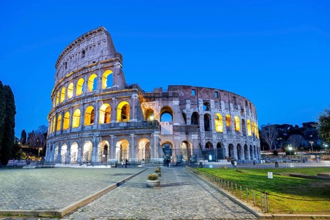Colosseum ancient amphitheatre at night in Rome, Italy
