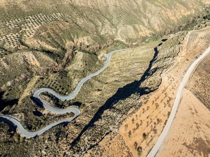 Deep canyon at the Gorafe desert, winding road to village Gorafe, aerial view, Gorafe Desert,
