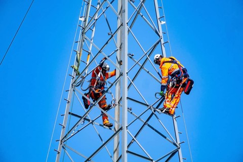 Fitters erecting a steel lattice tower as part of a 380 KV extra-high-voltage line between Wesel