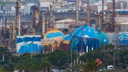 Factory complex with colorful painted tanks and urban background, capital city, Santa Cruz de
