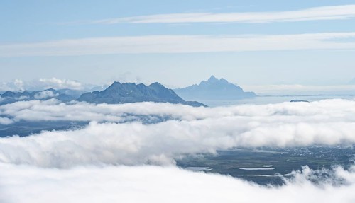Mountain peaks above the clouds, mountain landscape and sea, view from the summit of