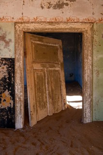 Interior view, doors and house full of sand, former diamond mining town, Namib Desert, Kolmanskop,