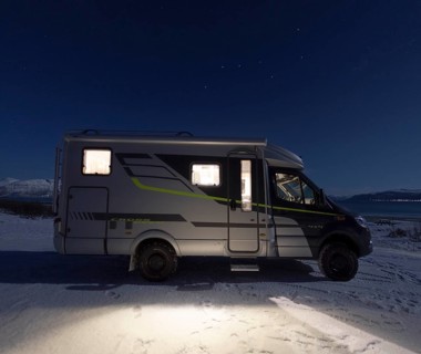 Motorhome in winter at night in front of the constellation of the Big Dipper (Ursa Major),