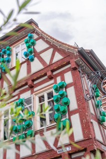 Detailed view of a half-timbered house with decorative green elements, Kirchheim Teck, Germany