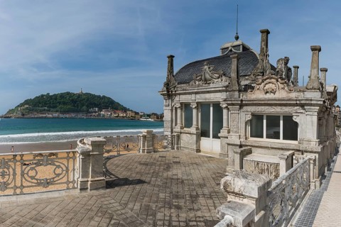 Summer at La Concha beach with historic bathhouse La Perla, San Sebastian, Basque Country, Spain