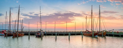 Sailboats and Zeesenboats in the harbour of Dierhagen on the Saaler Bodden at sunrise,