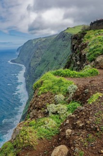 View of the cliffs and the Atlantic Ocean from the Ponta do Pargo lighthouse viewpoint in rainy