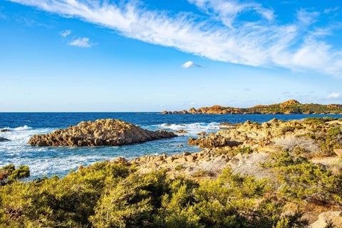Landscape of the coastline with blue water at Marinedda Coast on a sunny day, Sardinia, Italy