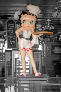 Figure of a waitress in a restaurant window, black and white, Newton, New Jersey, USA