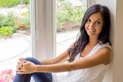 A young woman sits at the window and relaxes Studio shot, Vienna, Austria