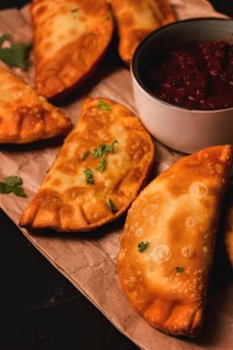 Fried mini pasties, with red sauce, top view, close-up, no people, selective focus