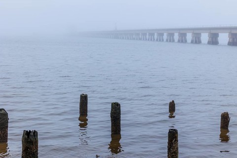 Railroad bridge over the Biloxi Bay disappears into the dense fog at Ocean Springs, Mississippi