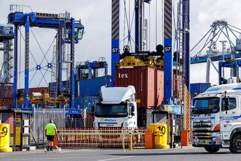 Port of Auckland container terminal with straddle carrier, Walters and Les Harrison trucks and