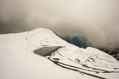 After snowfall in May: Riezler Alpsee, an artificial lake, snow pond, feeds the snow cannons that