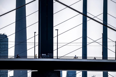 Oberkassler bridge over the Rhine near Düsseldorf, in front, behind the Rheinknie bridge, cyclist,