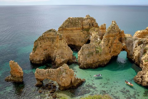 Excursion boats on the rocky coast near Lagos, Algarve, Portugal